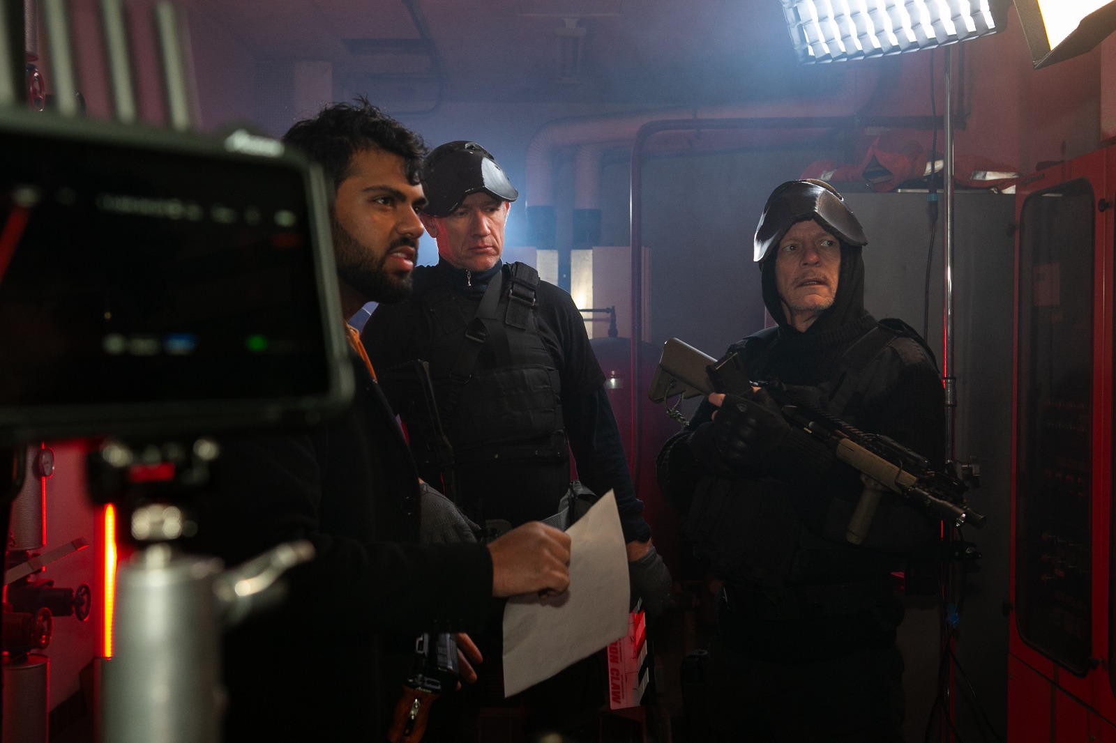 Behind the scenes on the Moon Claw set with cast and crew reviewing a scene.